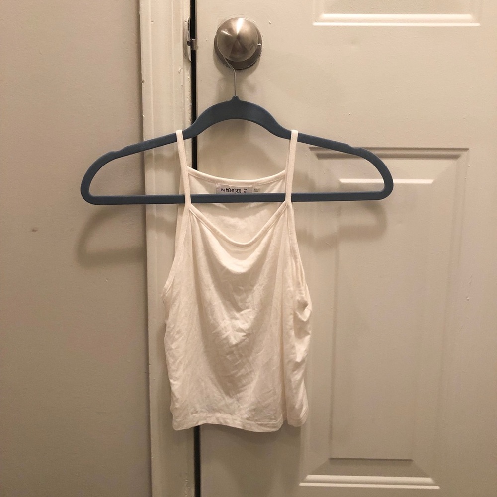 Small white crop top from Entourage Boutique.